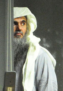 Abu_Qatada_and_escort_prior_to_take_off_(cropped)